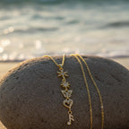SVORA gold plated stainless steel necklace with snowflake, star, butterfly, heart, and music note charms.