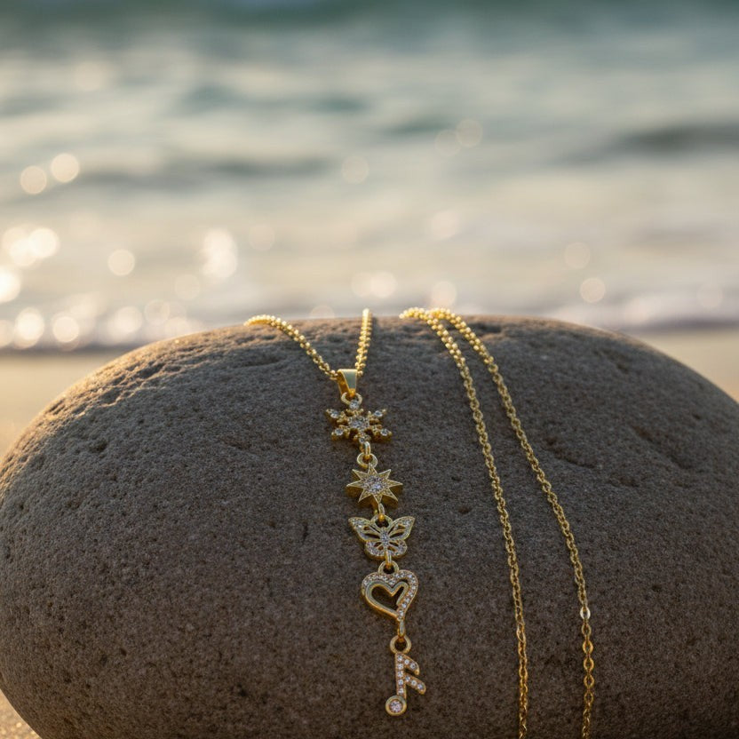SVORA gold plated stainless steel necklace with snowflake, star, butterfly, heart, and music note charms.