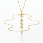 SVORA gold plated stainless steel necklace with snowflake, star, butterfly, heart, and music note charms.