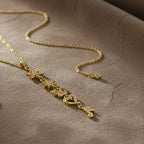 SVORA gold plated stainless steel necklace with snowflake, star, butterfly, heart, and ribbon charms.