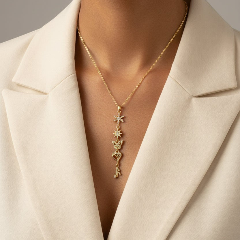 SVORA gold plated stainless steel necklace with snowflake, star, butterfly, heart, and musical note charms.
