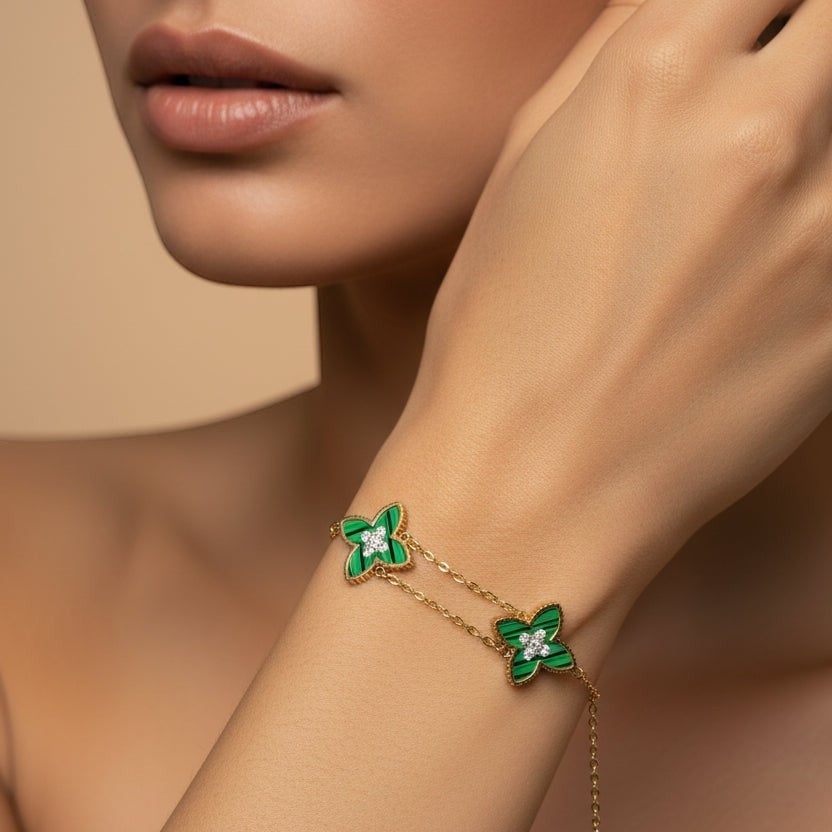 SVORA gold double-layered chain bracelet with two green clover charms, each with a diamond center.