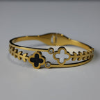SVORA gold plated stainless steel bracelet with black onyx and mother-of-pearl clover charms and cubic zirconia accents.