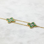 SVORA gold double-layered chain bracelet with two green clover charms, each with a diamond center.