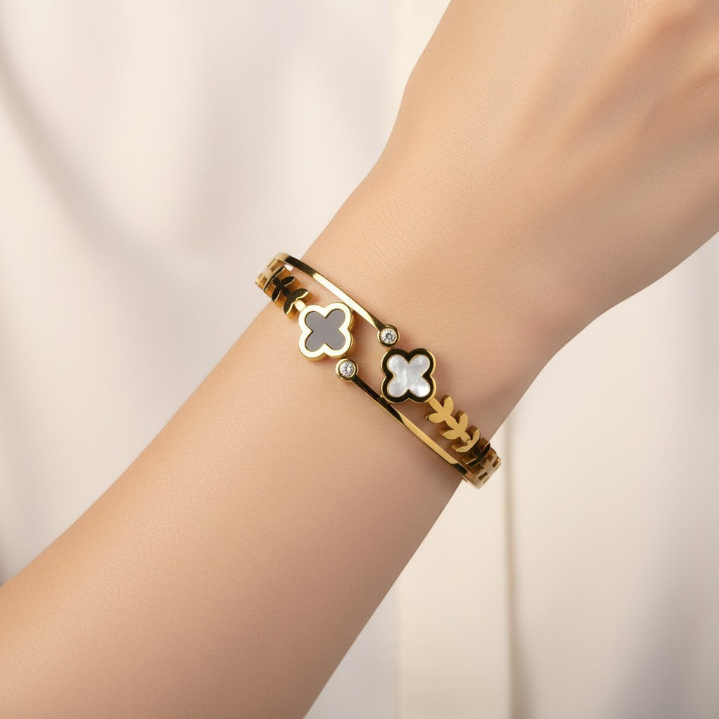 SVORA gold-plated stainless steel bracelet with black onyx and mother-of-pearl clover charms and diamond accents.