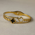 SVORA gold-plated stainless steel bracelet with black onyx and white mother-of-pearl clover charms and cubic zirconia accents.