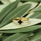 SVORA gold clover ring with black center and clear crystals on band, 18K gold plated stainless steel