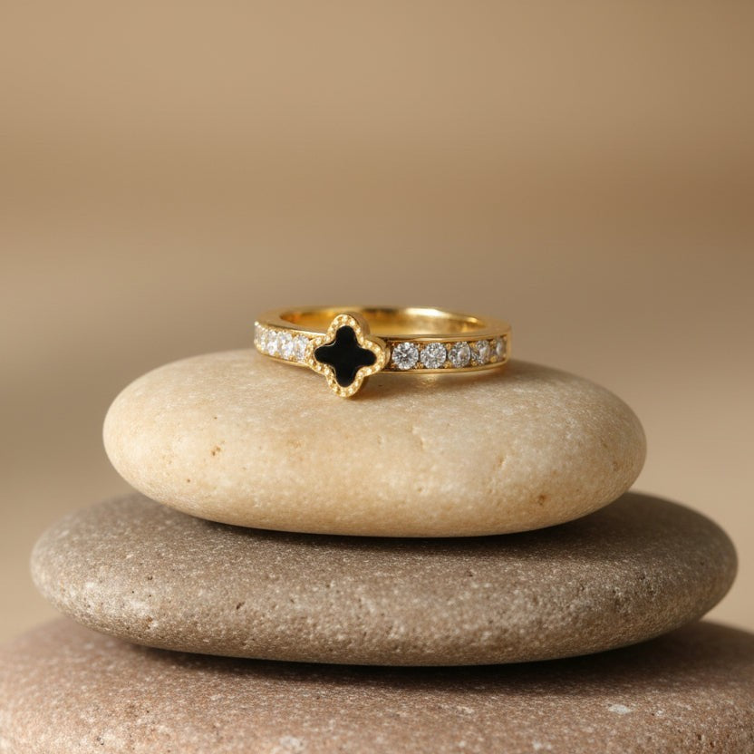 SVORA gold tone stainless steel ring with black clover motif and clear crystals. Waterproof, anti-tarnish, hypoallergenic.