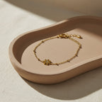 SVORA gold plated stainless steel daisy solitaire chain bracelet with cubic zirconia stone, adjustable lobster clasp.