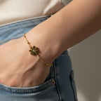 SVORA gold daisy solitaire chain bracelet with cubic zirconia center on a beaded chain, adjustable with lobster clasp.