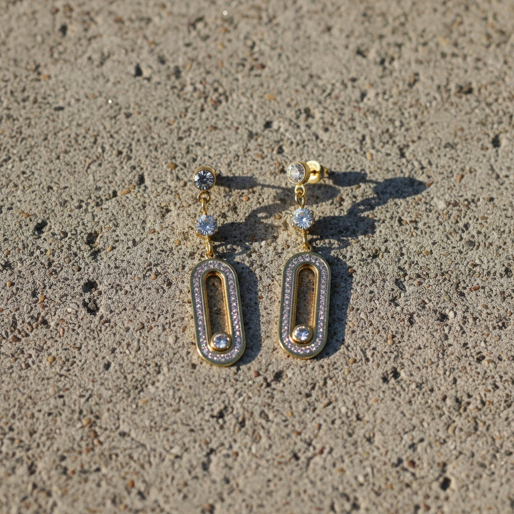 SVORA gold tone dangle earrings with cubic zirconia stones and a modern minimal silhouette, perfect for any neckline.