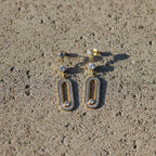 SVORA gold tone dangle earrings with cubic zirconia stones and a modern minimal silhouette, perfect for any neckline.
