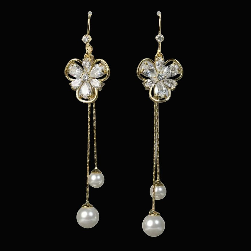 SVORA gold tone dangle earrings with cubic zirconia flower stud and pearl drop tassels.