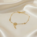 SVORA gold plated stainless steel bracelet with three heart charm, baguette CZs, and bead details. Adjustable.