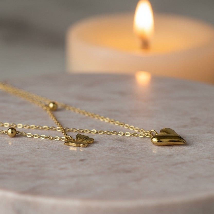 SVORA gold puffy heart and butterfly charm layered necklace made of stainless steel with 18k gold plating.