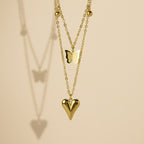 SVORA gold puffy heart and butterfly charm layered necklace made of stainless steel with 18k gold plating.