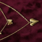 SVORA gold puffy heart and butterfly charm layered necklace made of stainless steel with 18k gold plating.