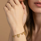 SVORA gold cable chain bracelet with three suspended heart charms and gold beads. 18K gold plated stainless steel.