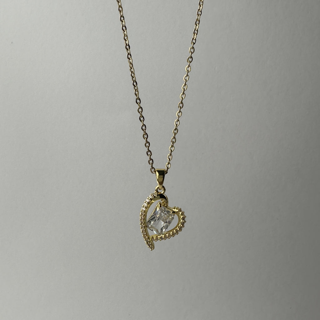 SVORA gold-plated stainless steel necklace with a heart-shaped pendant encrusted with small crystals and a central clear crystal.