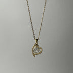 SVORA gold-plated stainless steel necklace with a heart-shaped pendant encrusted with small crystals and a central clear crystal.