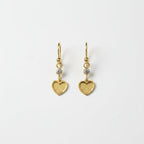 SVORA gold tone stainless steel dangle earrings with cubic zirconia and textured heart charms.
