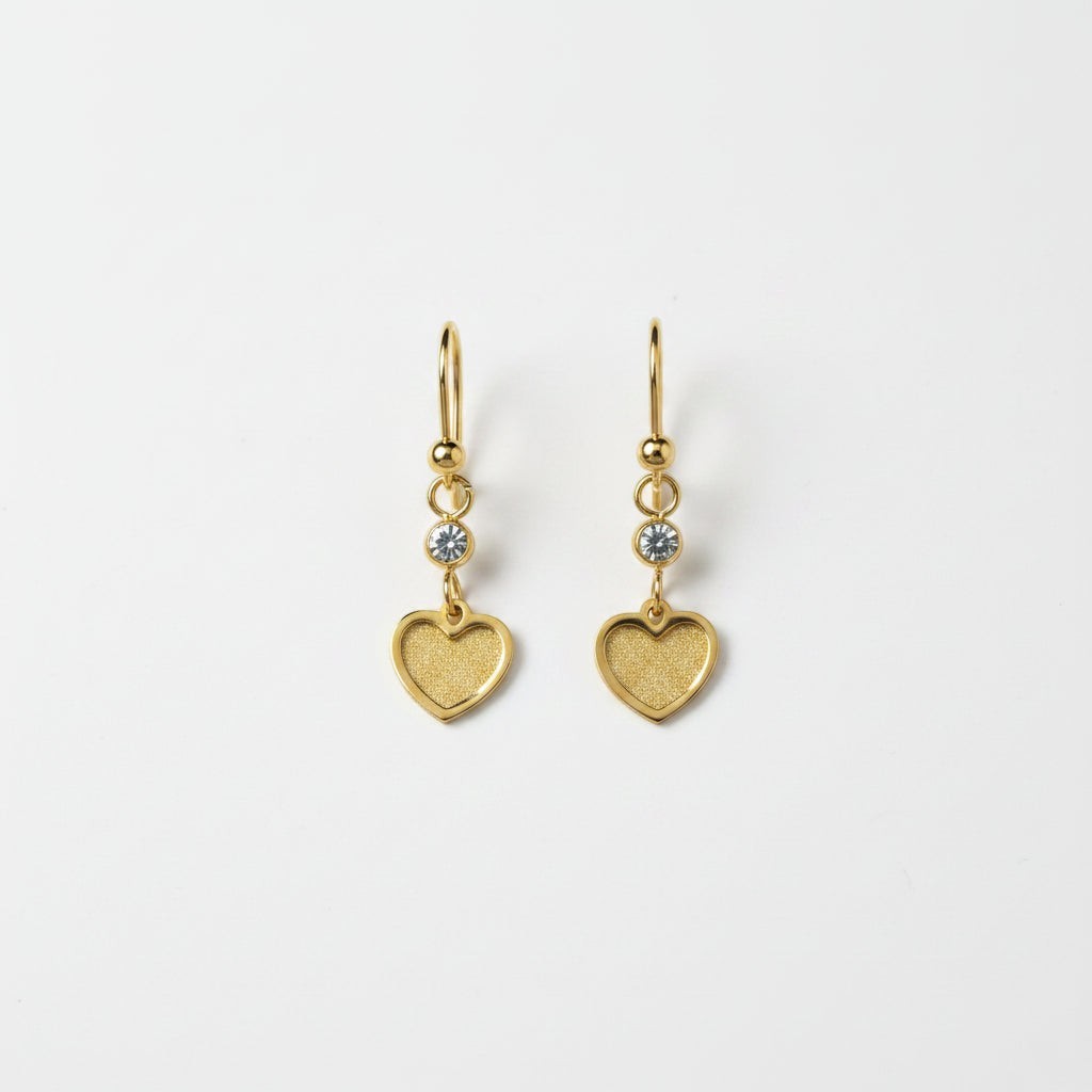 SVORA gold tone stainless steel dangle earrings with cubic zirconia and textured heart charms.