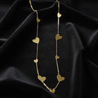 SVORA gold-tone stainless steel drape necklace with multiple polished heart charms on a delicate chain.