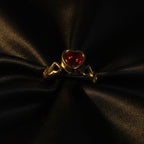 SVORA gold-plated stainless steel ring with a red heart-shaped cubic zirconia and heart details on the band.
