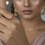 SVORA gold-plated stainless steel ring with a ruby red heart-shaped cubic zirconia and small heart details.