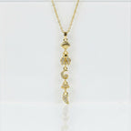 SVORA gold lariat necklace with shell, bee, moon, bell, and horn charms. 18K gold plated stainless steel.