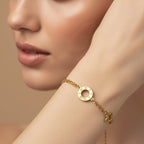 SVORA gold layered chain bracelet with hollow circle featuring Roman numerals and clover charm.