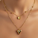 SVORA gold-tone stainless steel layered necklace with puffy heart and butterfly charms.
