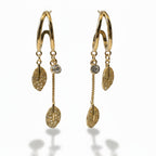 SVORA gold-plated stainless steel dangle earrings with crystal studs and pave leaf charms.