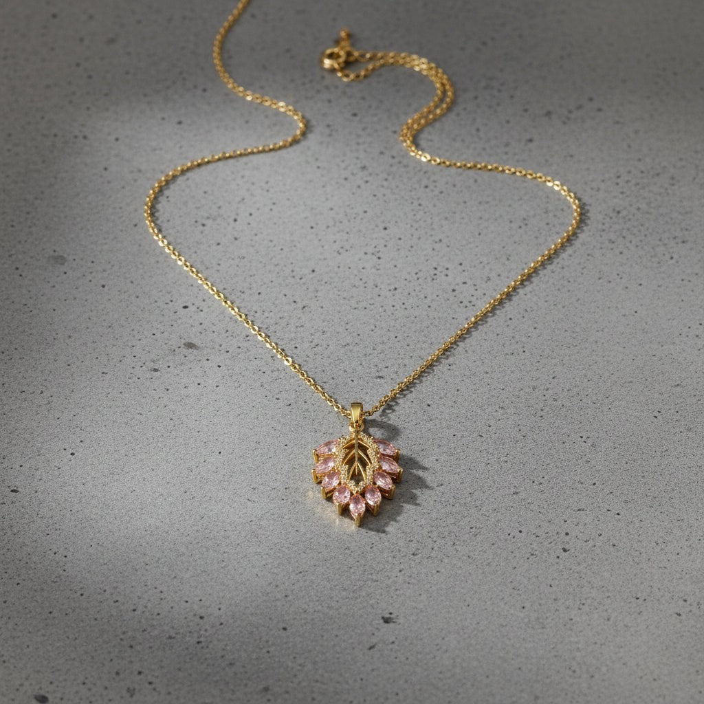 SVORA gold plated stainless steel necklace with a blush marquise leaf pendant adorned with pink and white CZ stones.