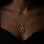 SVORA gold leaf pendant necklace with pink marquise CZ stones and white CZ accents on a delicate chain.