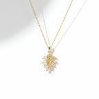 SVORA gold leaf cluster pendant with marquise CZ stones on a delicate chain. 18K gold plated stainless steel.