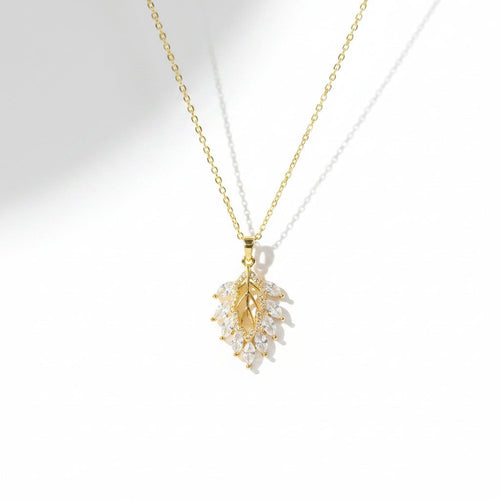 SVORA gold leaf cluster pendant with marquise CZ stones on a delicate chain. 18K gold plated stainless steel.