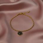 SVORA gold ball bead chain bracelet with black monogram disc charm. 18K gold plated, stainless steel.