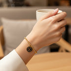 SVORA gold ball bead chain bracelet with black monogram disc charm. 18K gold plated, adjustable.