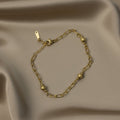 SVORA gold paperclip chain bracelet with spaced textured gold beads and lobster clasp. 18K gold plated stainless steel.