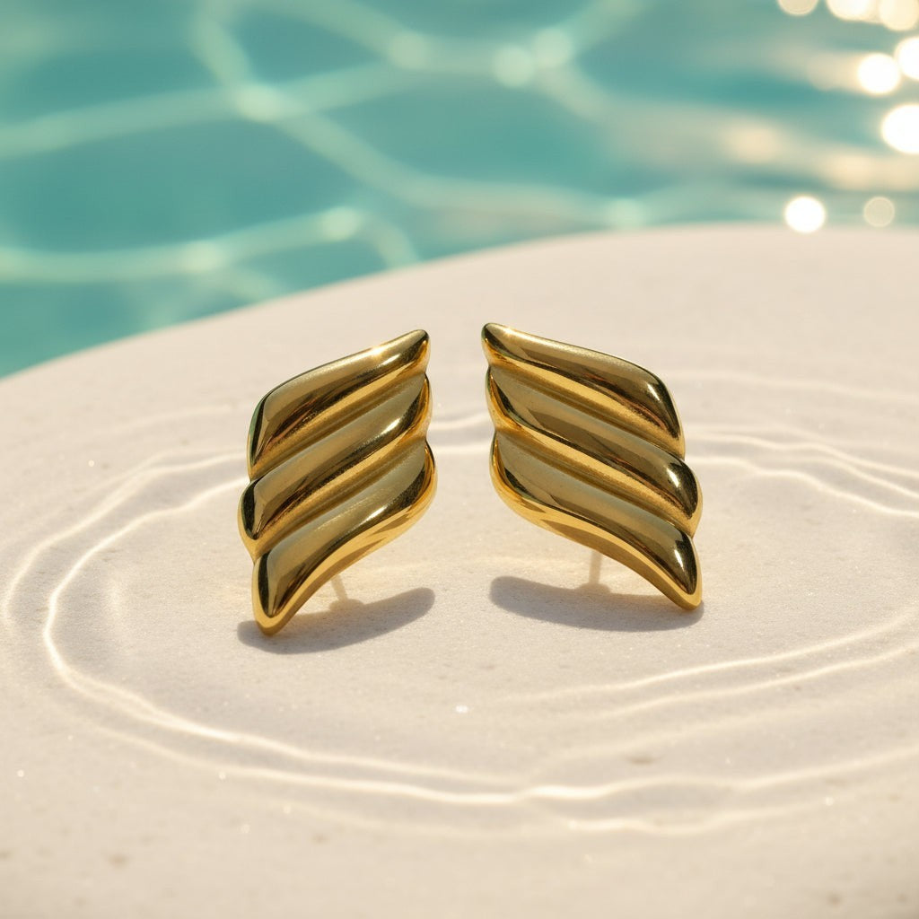 SVORA gold tone ribbed dome sculptural stud earrings with high polish finish.