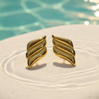 SVORA gold tone ribbed dome sculptural stud earrings with high polish finish.