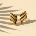 SVORA gold tone ribbed dome sculptural stud earrings with high polish finish.