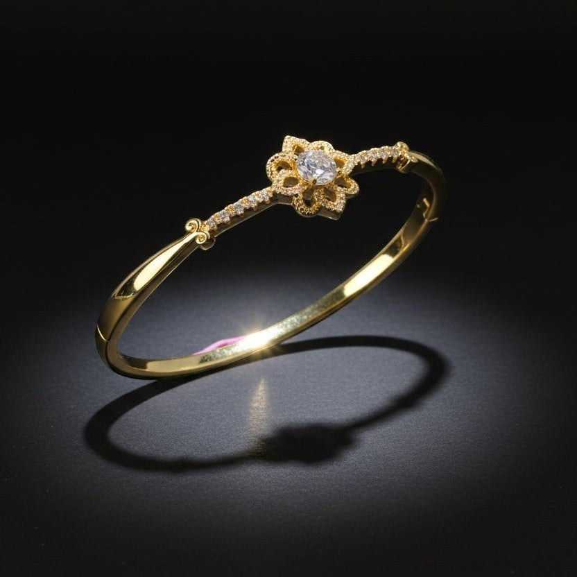 SVORA gold-plated stainless steel bracelet with a central solitaire CZ stone and milgrain detailing.