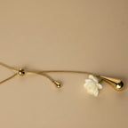 SVORA gold teardrop lariat necklace with adjustable snake chain and polished teardrop charms.