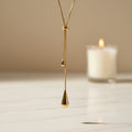 SVORA gold teardrop lariat necklace made of stainless steel with adjustable snake chain and polished charms.