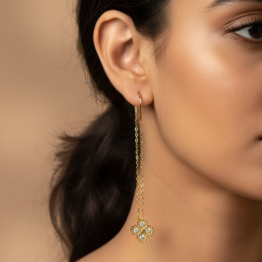 SVORA gold thread-through earrings with cubic zirconia clover charm. Delicate chain dangles.