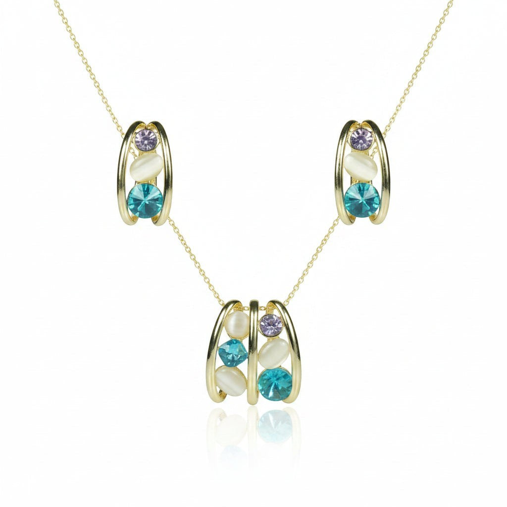 SVORA gold-tone necklace and earrings set with blue, lavender, and cream cabochon stones in a caged design.