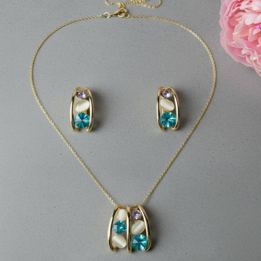 SVORA gold-tone necklace and earrings set with teal blue, lavender, and cream cabochon stones in a caged design.