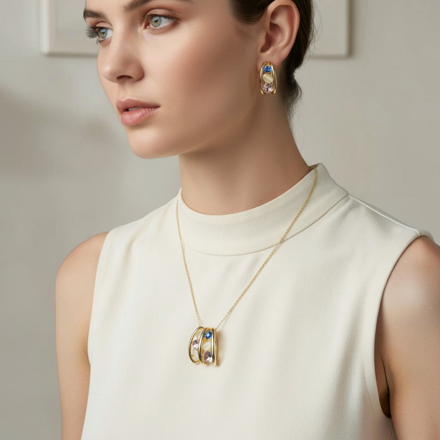 SVORA gold tone necklace and earrings set with pink, blue, and cream cabochon stones.